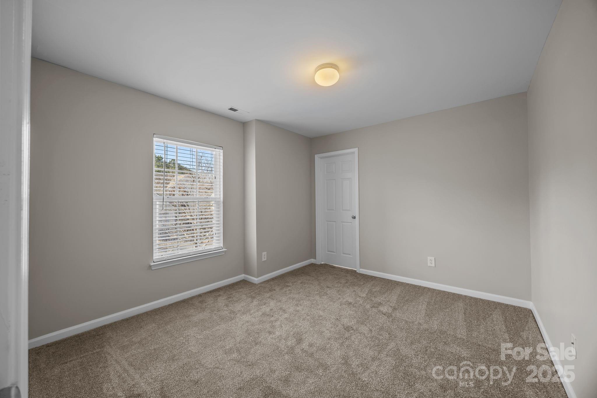 3422 Burnage Hall Road Harrisburg, NC 28075 - Photo 33 of 42 an empty room with windows