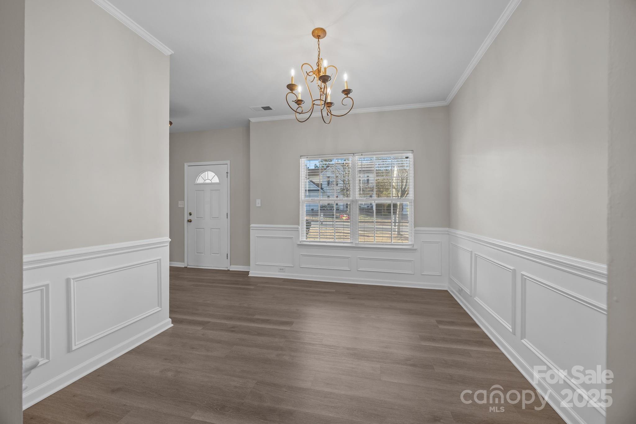 3422 Burnage Hall Road Harrisburg, NC 28075 - Photo 10 of 42 wooden floor in an empty room with a window