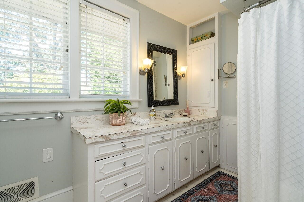 13 Furches Street Raleigh, NC 27607 - Photo 26 of 37 a bathroom with a double vanity sink a mirror and a shower