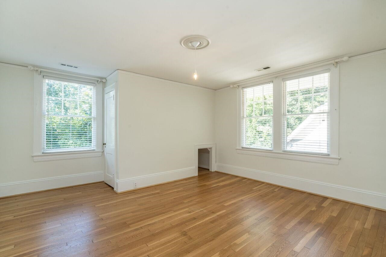 13 Furches Street Raleigh, NC 27607 - Photo 27 of 37 a view of an empty room with wooden floor and a window