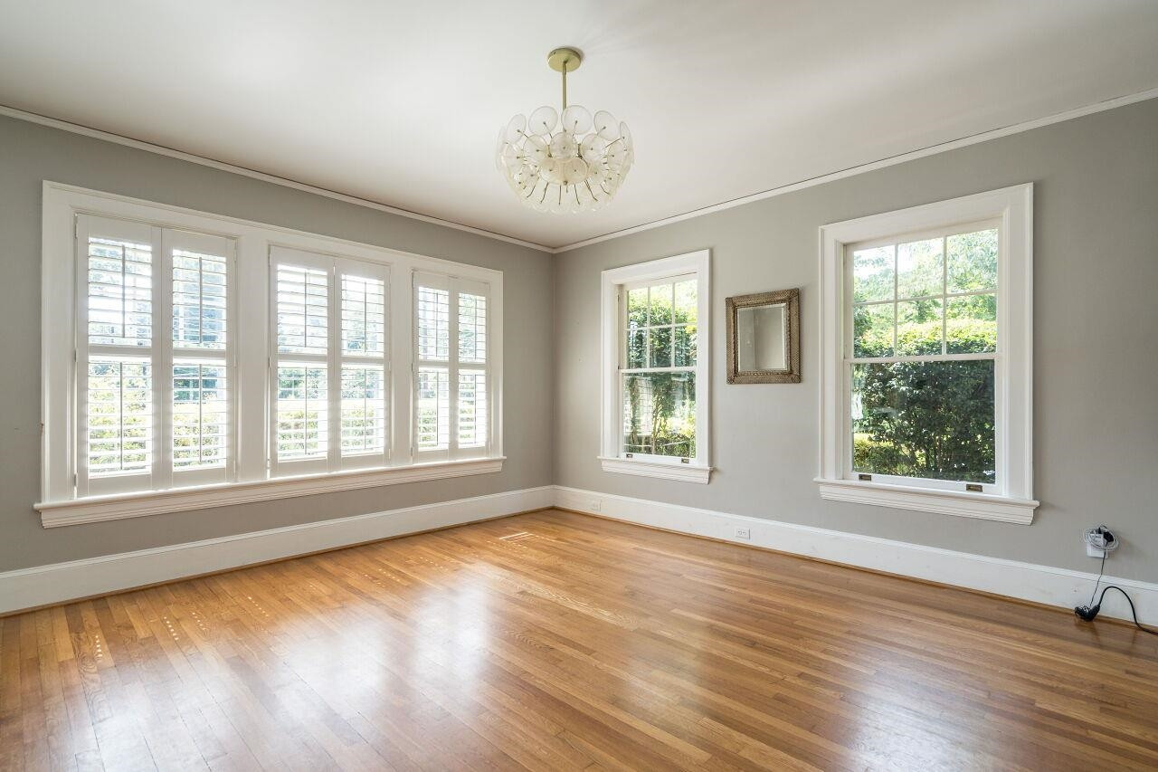13 Furches Street Raleigh, NC 27607 - Photo 8 of 37 a view of an empty room with wooden floor and a window