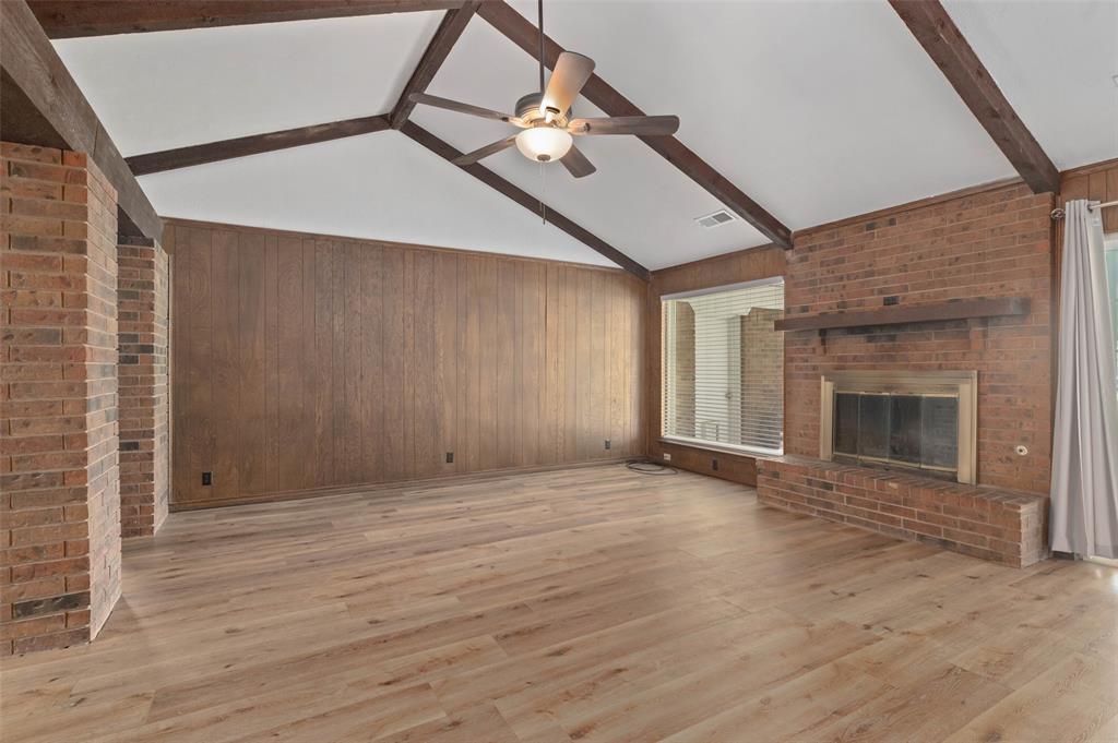 301 East 6th Street Krum, TX 76249 - Photo 5 of 29 Huge living area with vaulted ceiling, ceiling fan and fireplace with gas starter.
