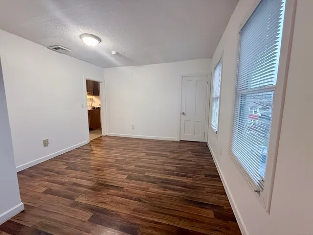 a view of a room with wooden floor and staircase