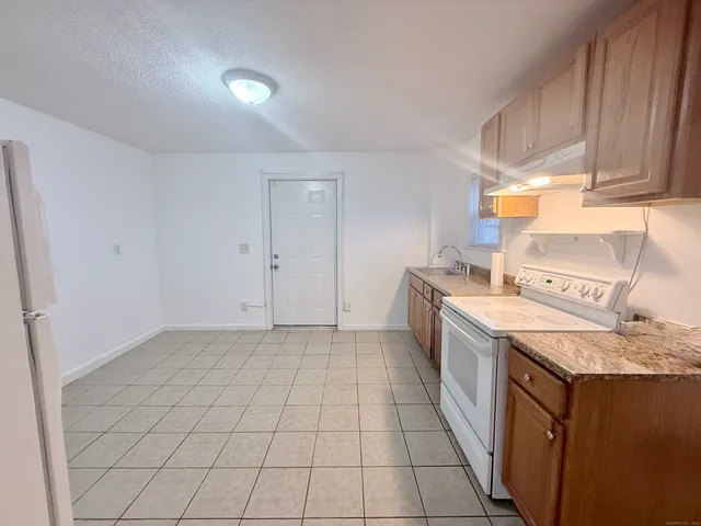 a kitchen that has a sink and a stove