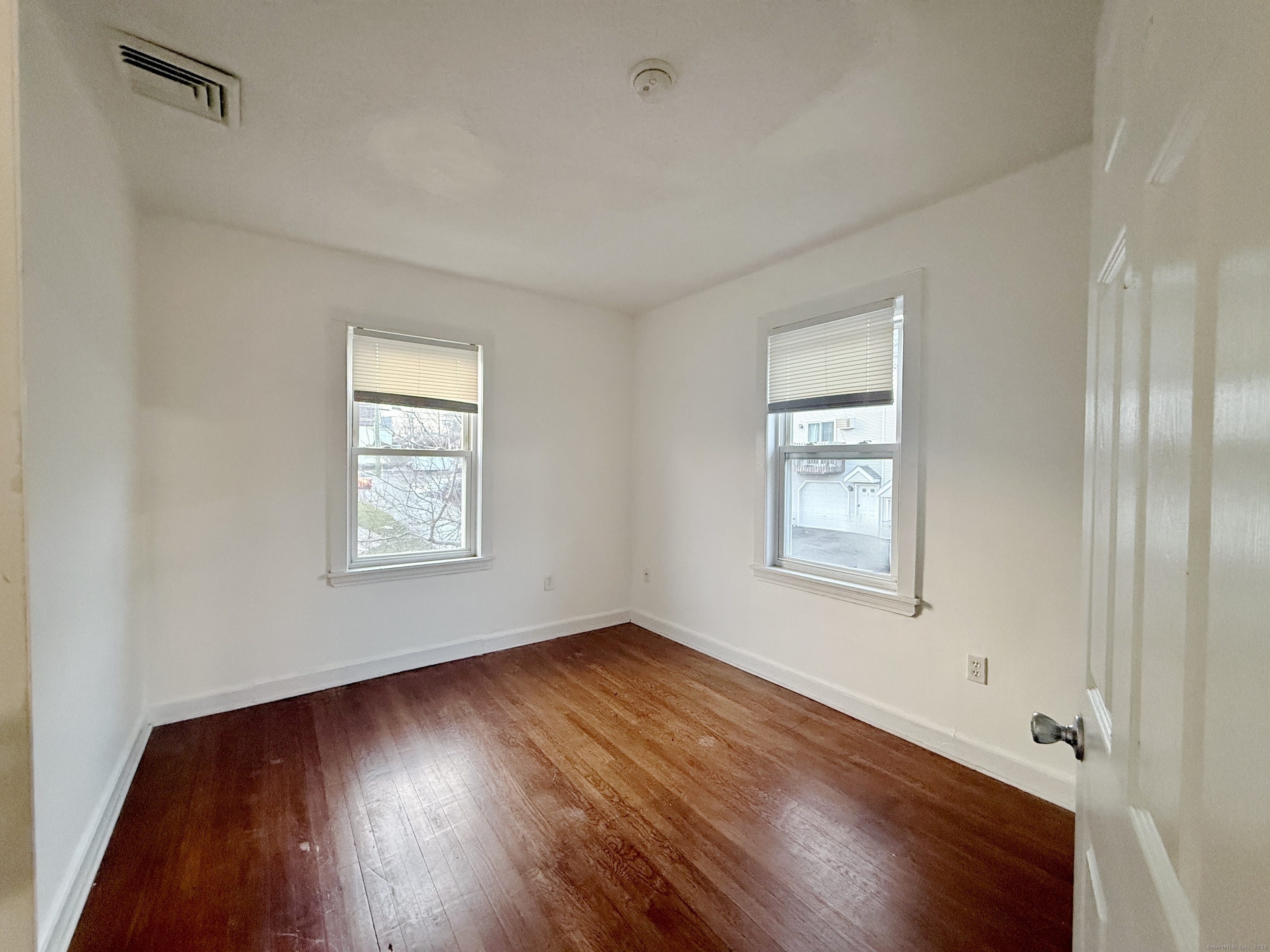 12 South Street New Britain, CT 06051 - Photo 7 of 9 a view of an empty room with wooden floor and a window