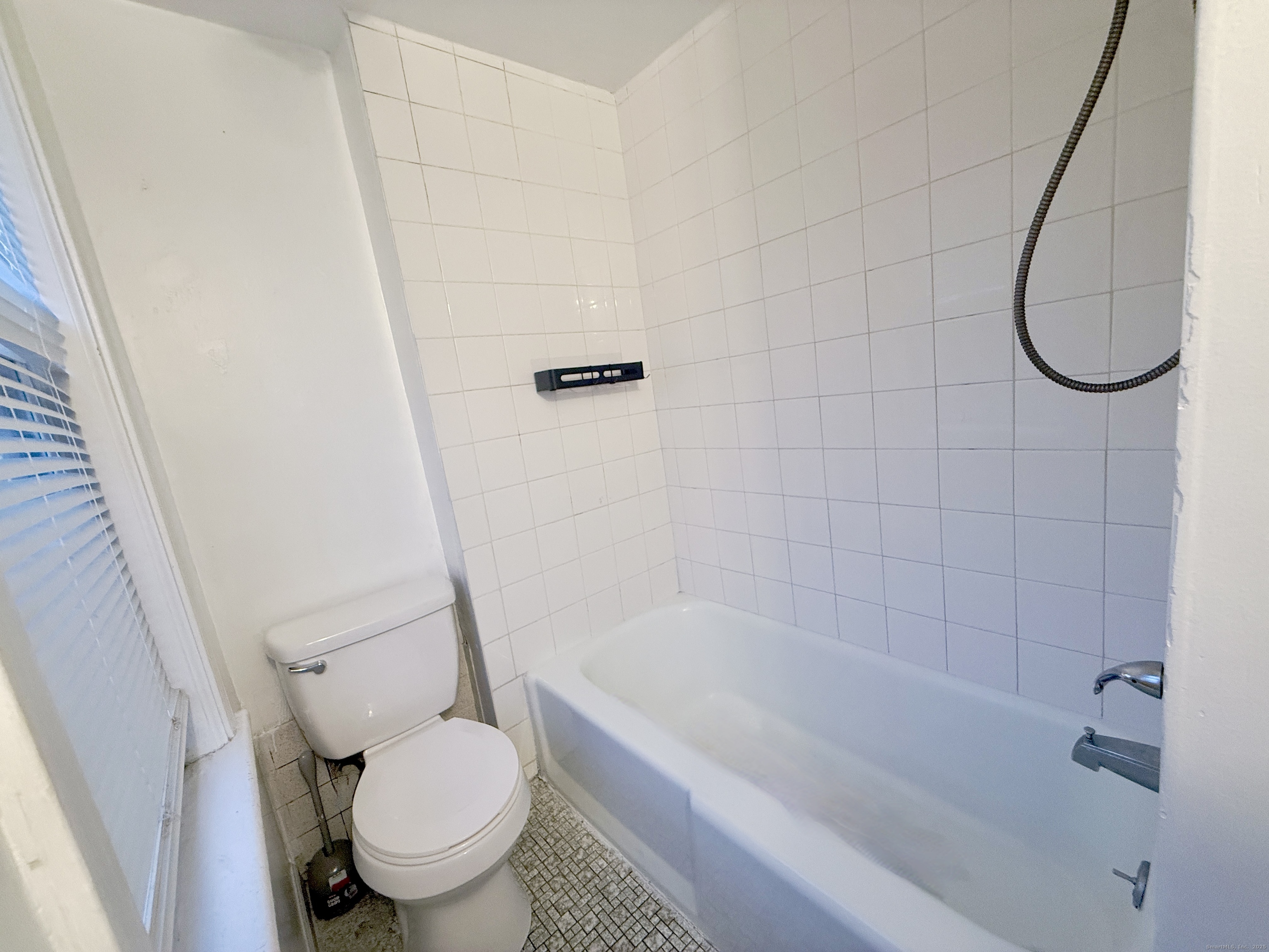 12 South Street New Britain, CT 06051 - Photo 9 of 9 a white toilet sitting next to a bath tub