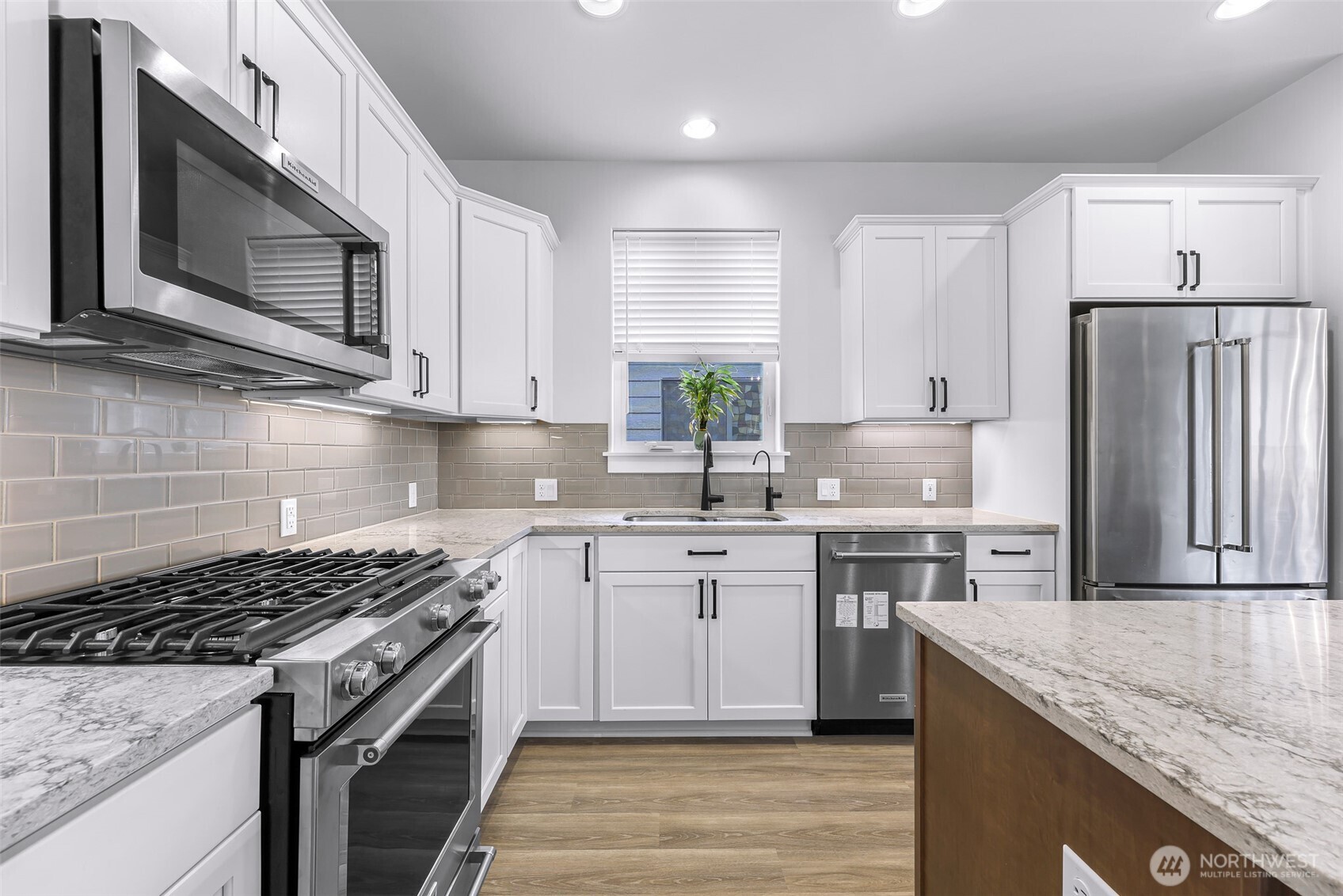 1396 Woods Point Loop Ferndale, WA 98248 - Photo 11 of 32 a kitchen with stainless steel appliances granite countertop a stove microwave sink and refrigerator