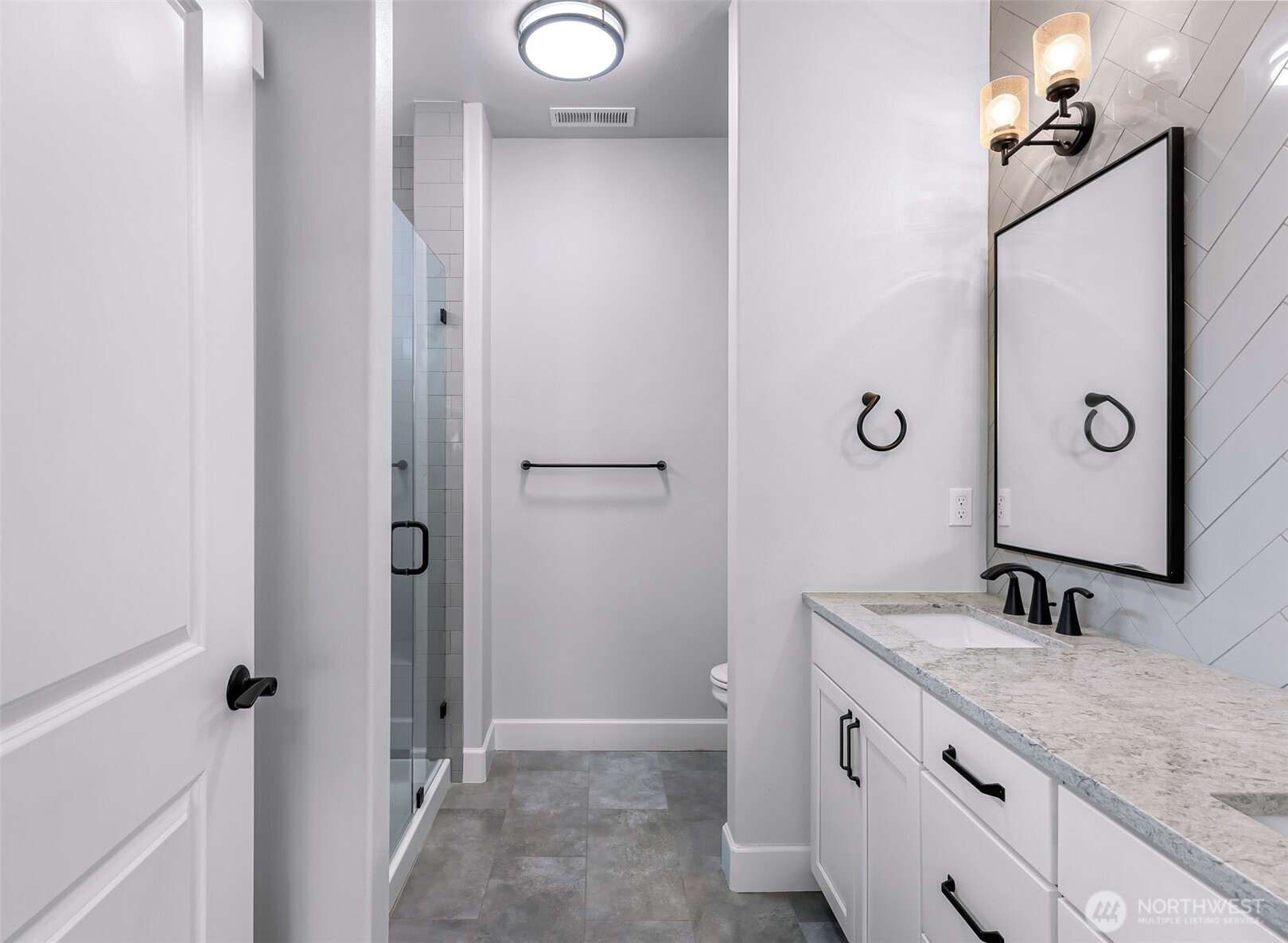 1396 Woods Point Loop Ferndale, WA 98248 - Photo 20 of 32 a bathroom with a double vanity sink and mirror