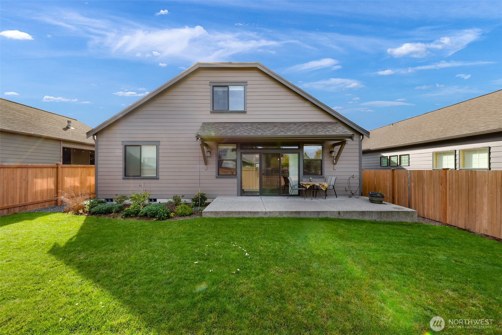 1396 Woods Point Loop Ferndale, WA 98248 - Photo 32 of 32 a view of a house with a yard and sitting area