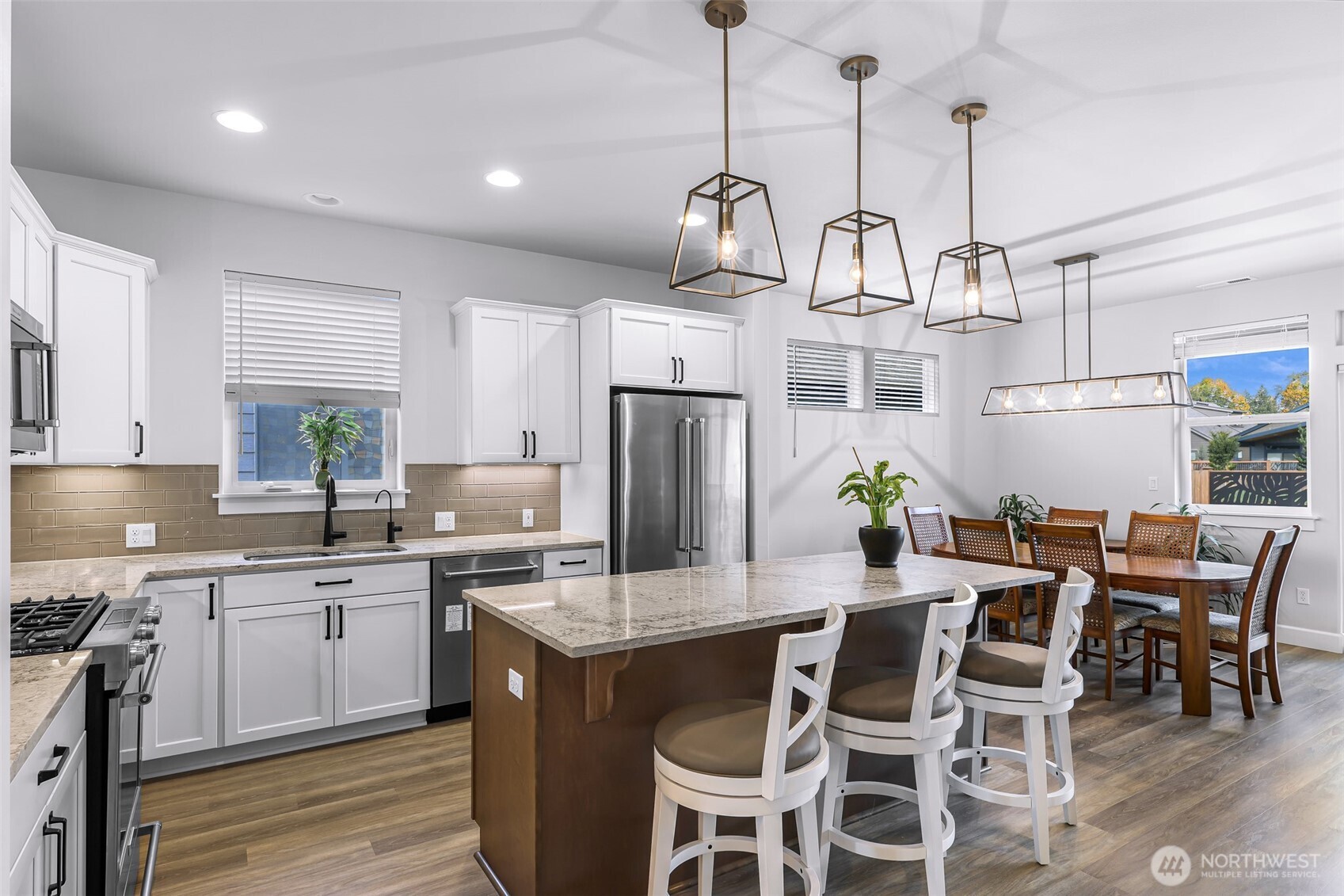 1396 Woods Point Loop Ferndale, WA 98248 - Photo 6 of 32 a kitchen with stainless steel appliances granite countertop a sink a stove a refrigerator and island with wooden floor
