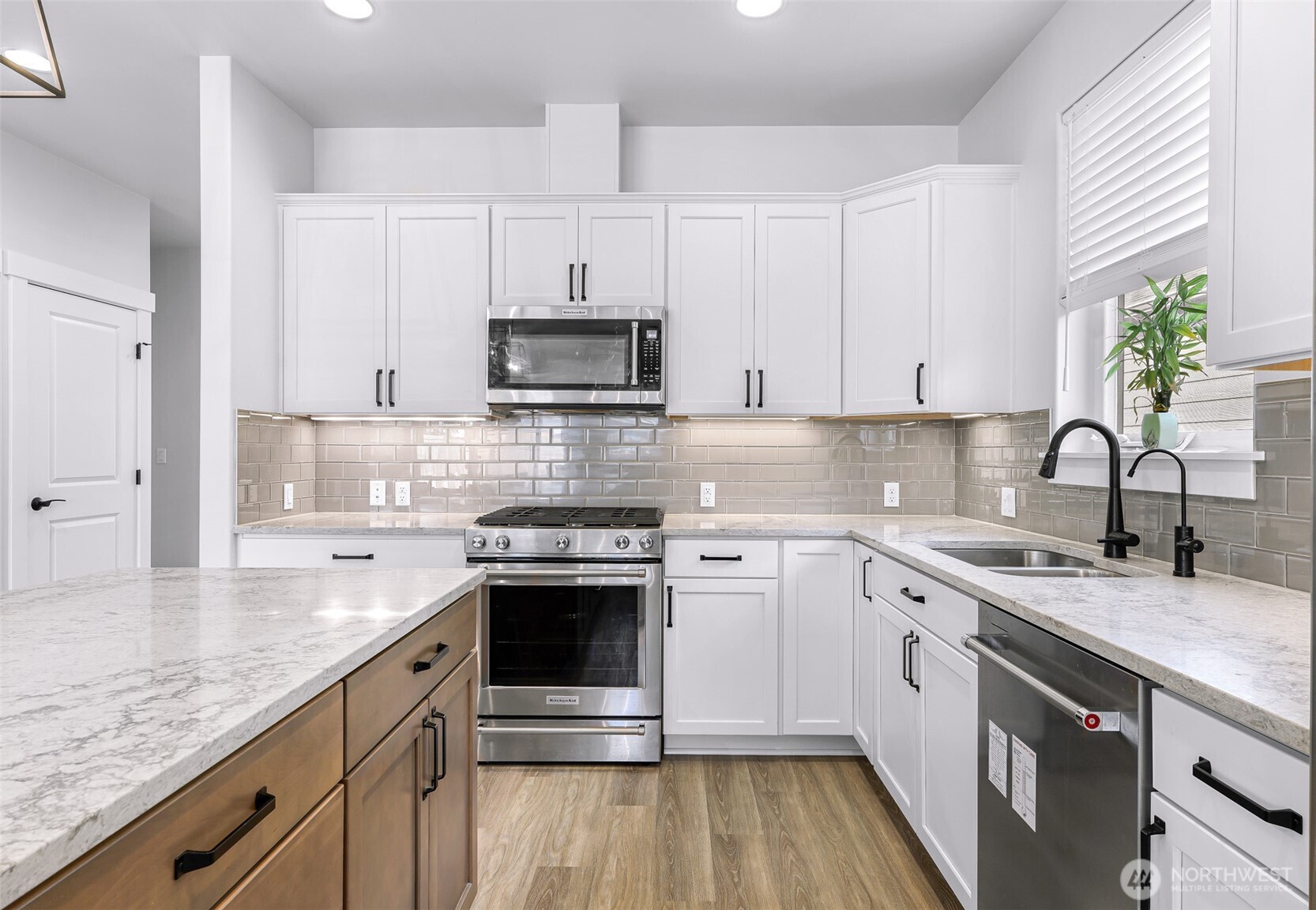 1396 Woods Point Loop Ferndale, WA 98248 - Photo 10 of 32 a kitchen with stainless steel appliances granite countertop a sink stove and cabinets