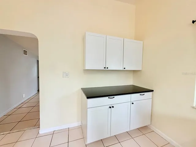 a kitchen with white cabinets