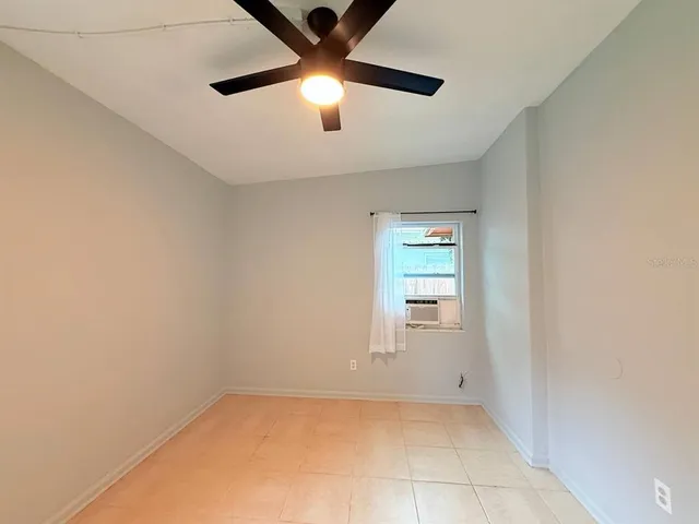 an empty room with closet and windows