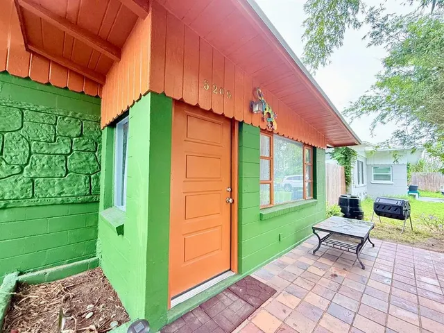 a backyard of a house with outdoor seating