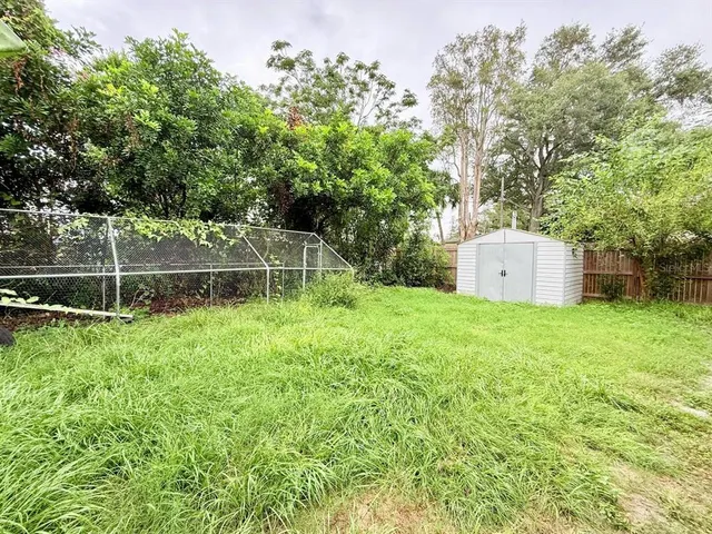 a view of a backyard with a garden and entertaining space