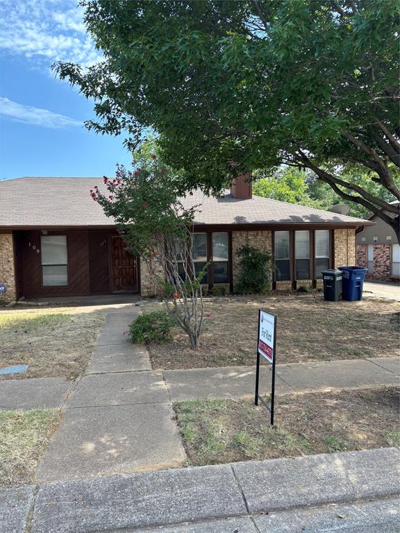a front view of a house with a yard and a garage