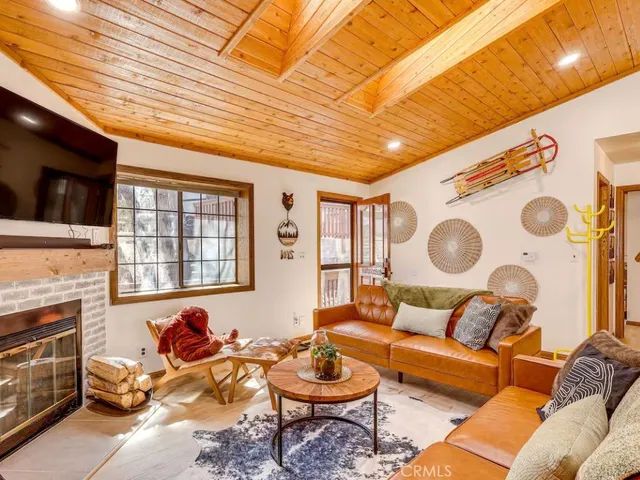 a living room with fireplace furniture and a flat screen tv
