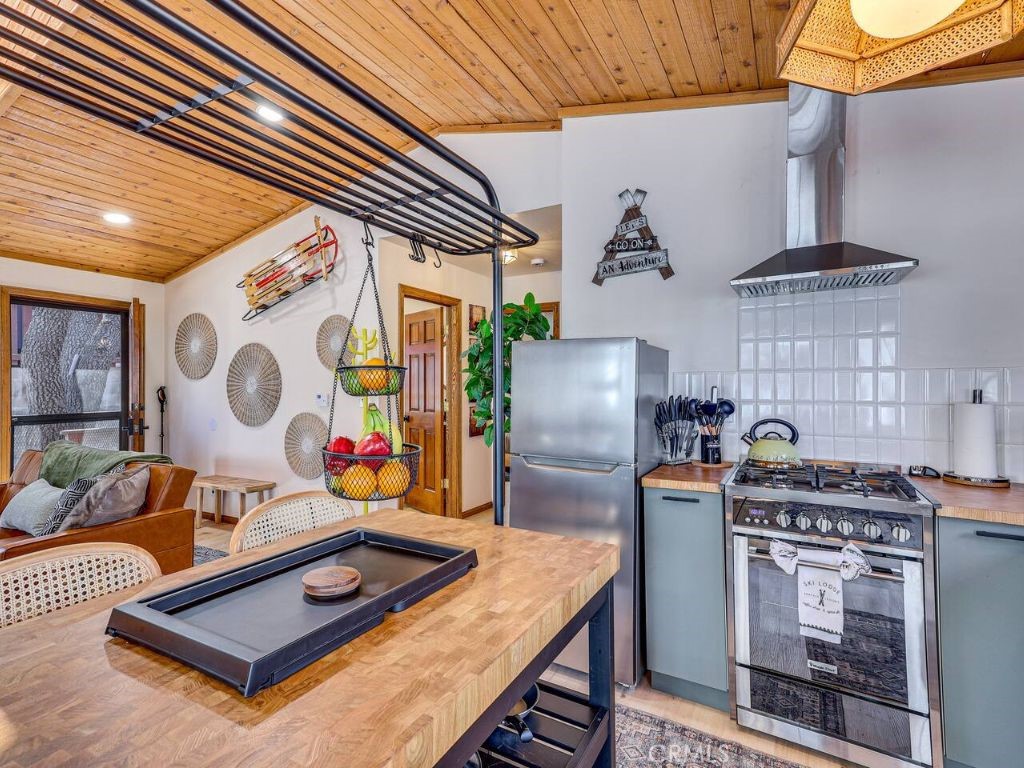 452 Orange Sugarloaf, CA 92386 - Photo 11 of 29 a kitchen with stainless steel appliances granite countertop a stove a sink and a microwave