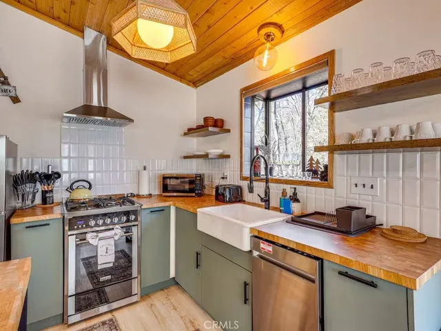 a kitchen with a stove a sink and a refrigerator