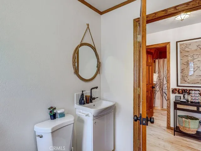a bathroom with a toilet a sink and a mirror