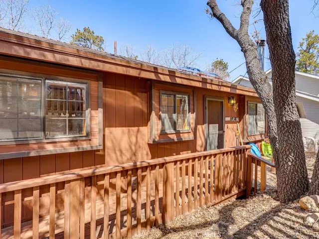 a view of a house with a wooden fence