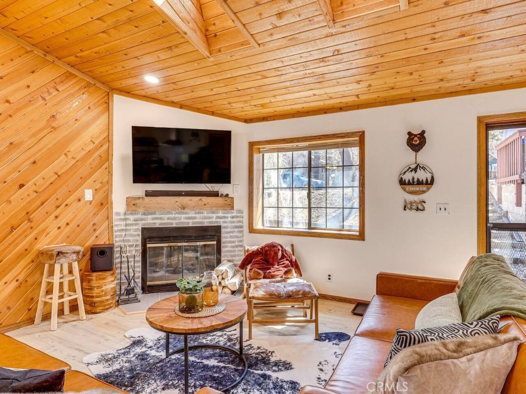 452 Orange Sugarloaf, CA 92386 - Photo 6 of 29 a living room with furniture a fireplace and a flat screen tv