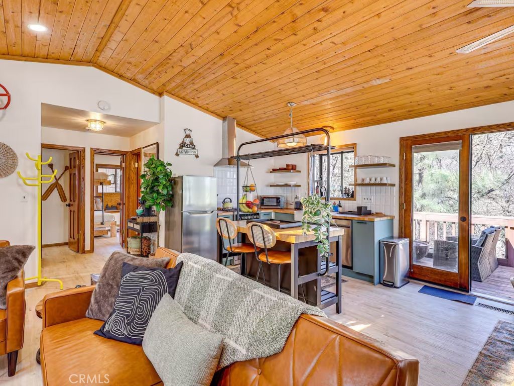 452 Orange Sugarloaf, CA 92386 - Photo 7 of 29 a living room with furniture kitchen view and a large window