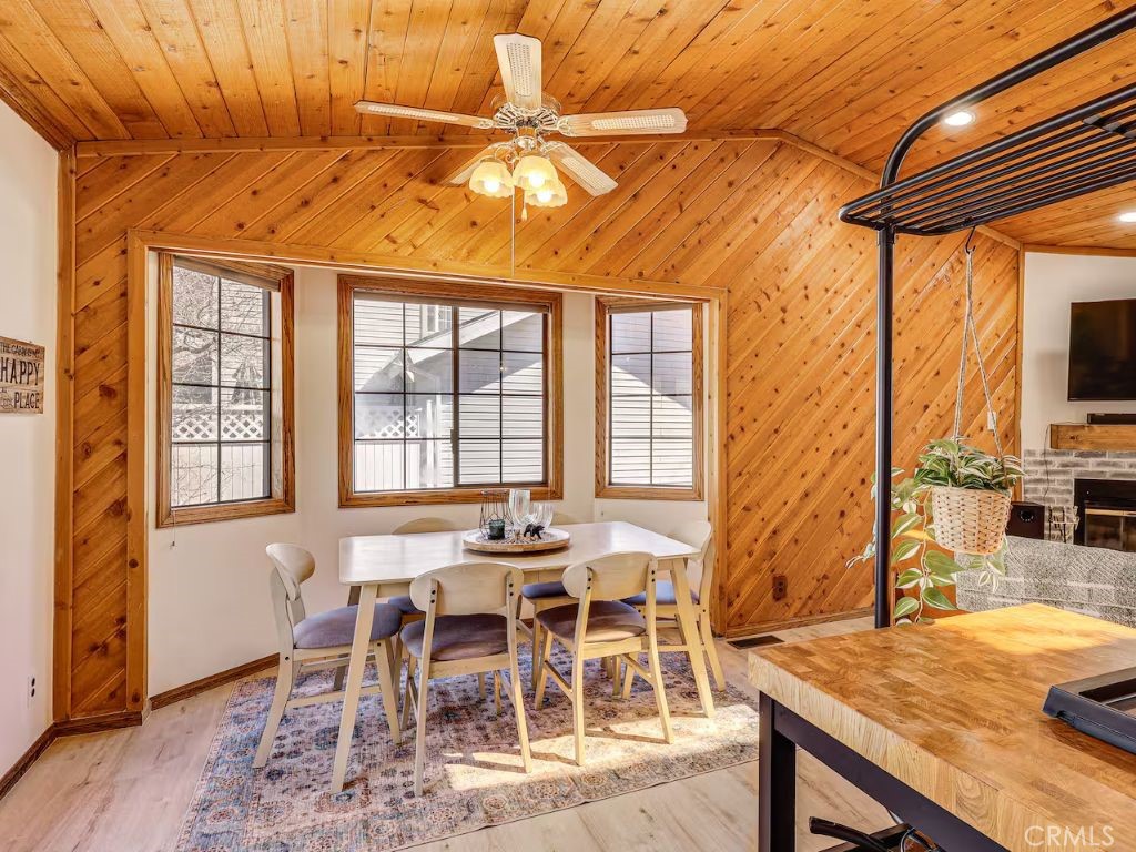452 Orange Sugarloaf, CA 92386 - Photo 8 of 29 a dining room with furniture a floor to ceiling window and wooden floor