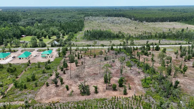 an aerial view of a houses with a yard