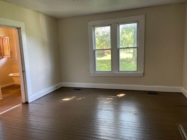 301 Bennett Street Decherd, TN 37324 - Photo 15 of 35 an empty room with wooden floor and windows