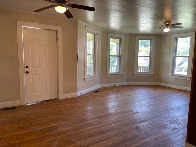 301 Bennett Street Decherd, TN 37324 - Photo 3 of 35 an empty room with wooden floor and windows