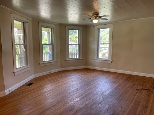 301 Bennett Street Decherd, TN 37324 - Photo 6 of 41 a view of an empty room with wooden floor and a window