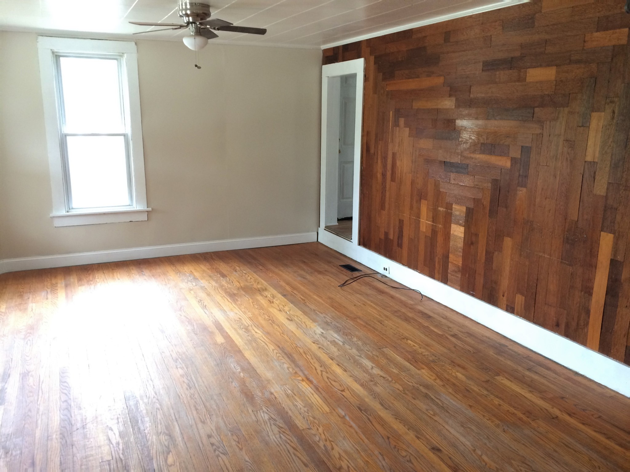 301 Bennett Street Decherd, TN 37324 - Photo 9 of 41 a view of an empty room with wooden floor and a window