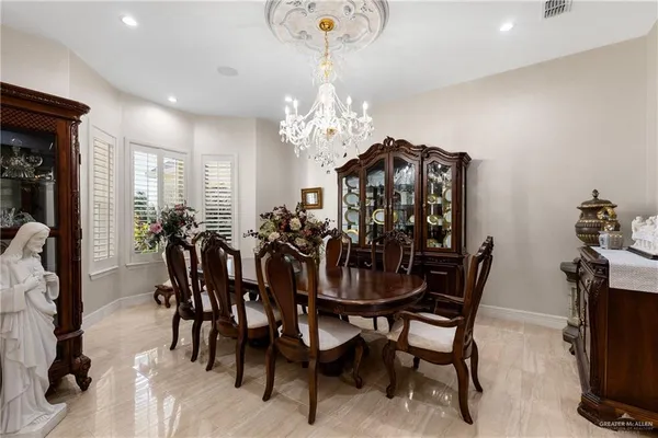a view of a dining room with furniture and chandelier