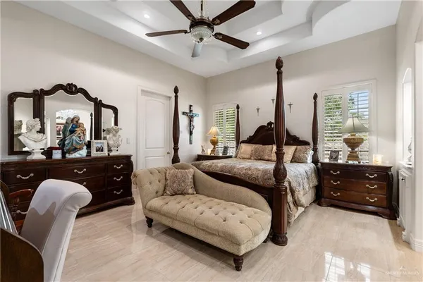 a bedroom with a bed a couch and dresser