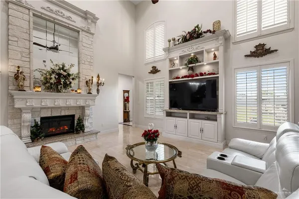 a living room with furniture a flat screen tv and a fireplace