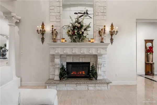 a living room with a fireplace and a potted plant