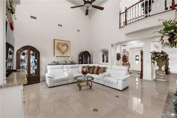 a living room with furniture and a potted plant