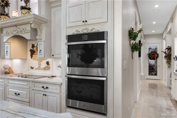 a kitchen with granite countertop white cabinets and white appliances