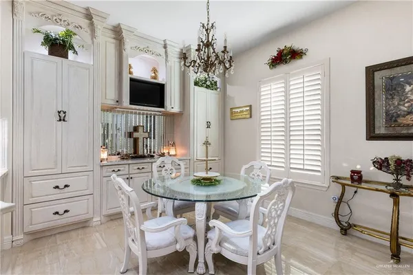 a dining room with furniture potted plants and wooden floor