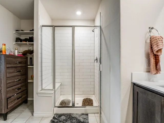 a bathroom with a double vanity sink and a mirror