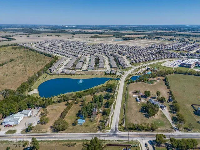 an aerial view of a house with a swimming pool patio and outdoor seating