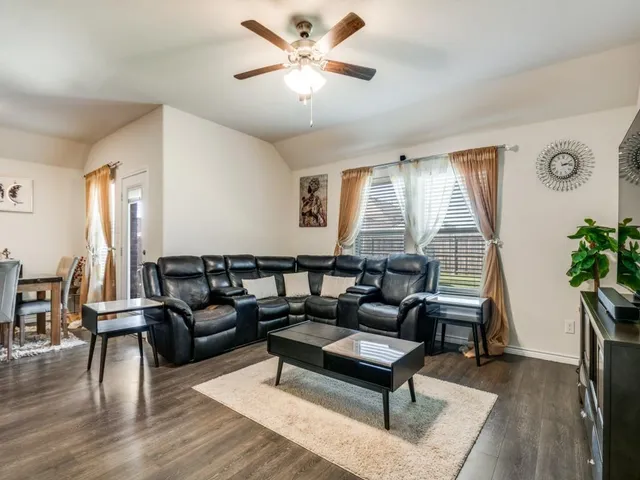 a living room with furniture and wooden floor