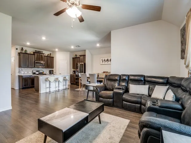 a living room with furniture and kitchen view