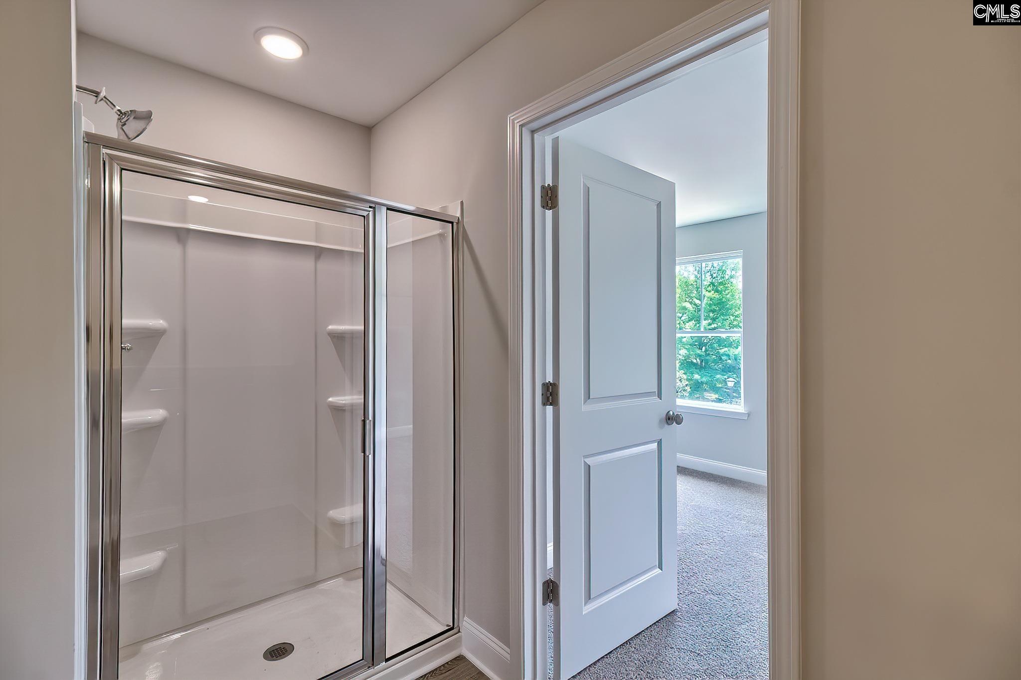 265 Eastover Road Eastover, SC 29044 - Photo 7 of 15 a bathroom with a glass shower door and a window