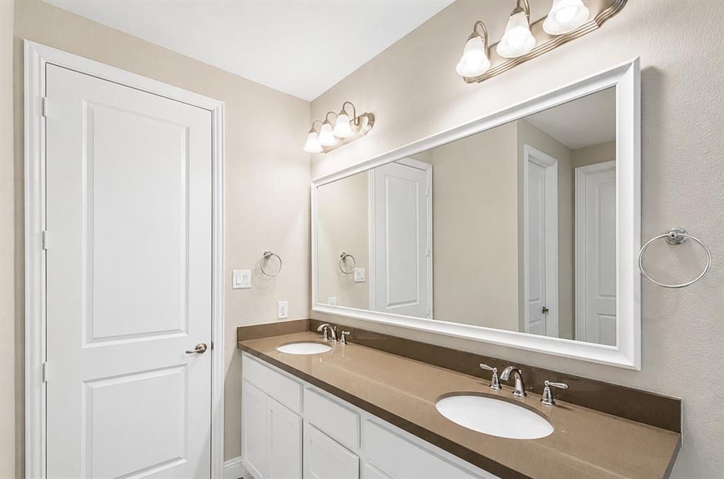 6209 Cupleaf Road Flower Mound, TX 76226 - Photo 24 of 29 Bathroom vanity with dual undermount sinks, bronze-toned countertop, and chrome fixtures