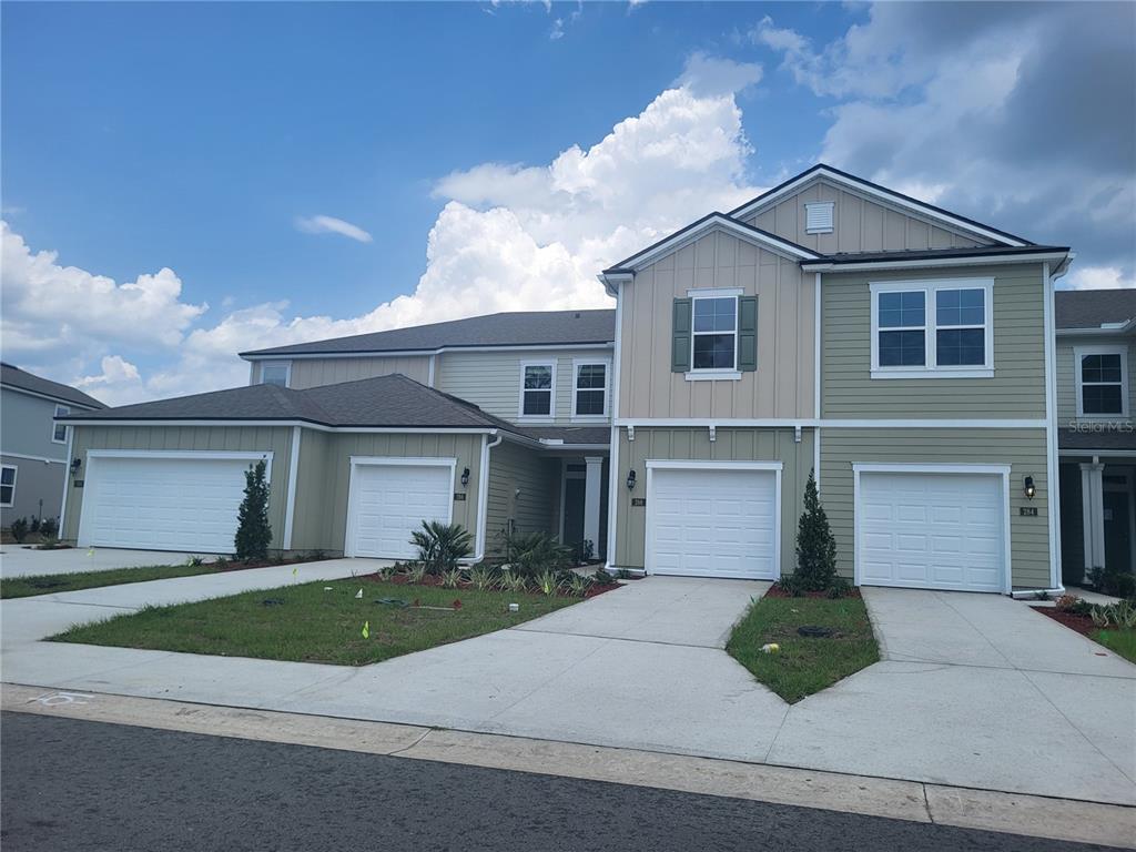 290 Redbud Road Palm Coast, FL 32137 - Photo 1 of 1 a front view of a house with a yard and garage
