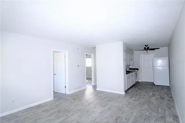 a view of a kitchen and a refrigerator