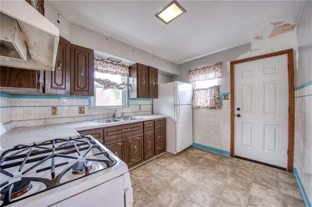 a kitchen with a stove a sink and a refrigerator