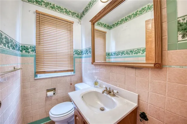 a bathroom with a sink a toilet and a window